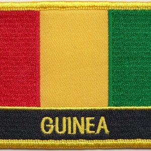 May include: A red, yellow, and green embroidered patch with the word "GUINEA" in yellow lettering on a black background. The patch has a yellow border.
