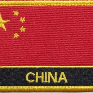 Op de afbeelding: Een rood geborduurd patch met een gele vijfpuntige ster en vier kleinere sterren in een halve cirkel. De patch heeft een zwarte rand met het woord "CHINA" in gele letters.
