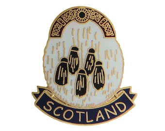 May include: Gold-colored pin with a white and black thistle design and a blue banner with the word "SCOTLAND" in gold letters.