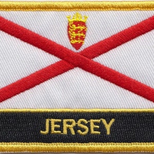 May include: A red and white embroidered patch with a gold border and the word "JERSEY" in gold lettering on a black background.