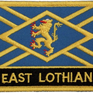 May include: A blue and gold embroidered patch with a lion and the text "EAST LOTHIAN".