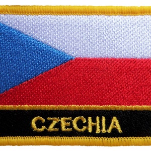 May include: A yellow embroidered patch with the Czech Republic flag and the word "CZECHIA" in gold lettering on a black background.