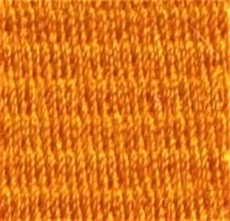 May include: A close-up of a textured orange fabric with a repeating pattern.