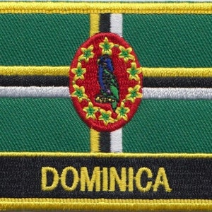 May include: An embroidered patch in green, black, white and yellow with the word "DOMINICA" in yellow lettering. The patch features a red circle with a green parrot and yellow stars.
