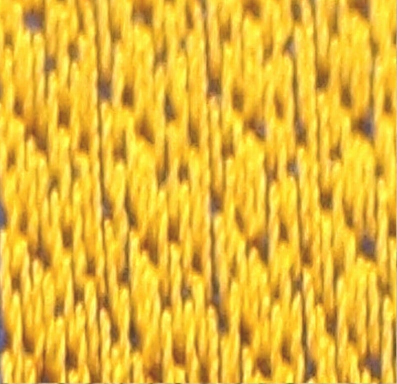 May include: Close-up of a yellow fabric with a textured, woven pattern.