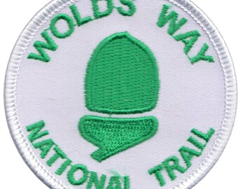 May include: White embroidered patch with a green acorn design and the text "Wolds Way National Trail".