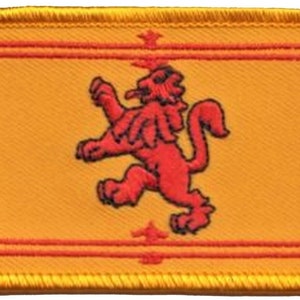 May include: A yellow embroidered patch featuring a red lion rampant, the national symbol of Scotland.