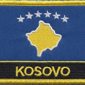 May include: A blue fabric patch with a yellow outline and a yellow map of Kosovo with a white outline. Six white stars are arranged in a semi-circle above the map. The text "KOSOVO" is written in yellow letters on a black background.