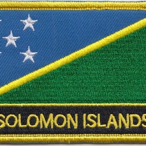 May include: A blue and green embroidered patch with five white stars and the text "SOLOMON ISLANDS" in yellow lettering.