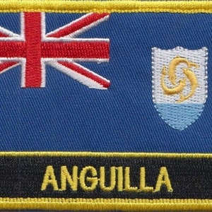 May include: A blue and yellow embroidered patch with the flag of Anguilla. The flag features a Union Jack in the upper left corner and the Anguilla coat of arms in the upper right corner. The words "Anguilla" are embroidered in yellow on a black background at the bottom of the patch.