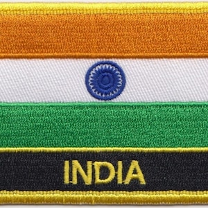 May include: An embroidered patch featuring the Indian flag. The flag is a tri-colour of saffron, white, and green with a blue wheel in the centre of the white stripe. The word "INDIA" is embroidered in yellow on a black background at the bottom of the patch.