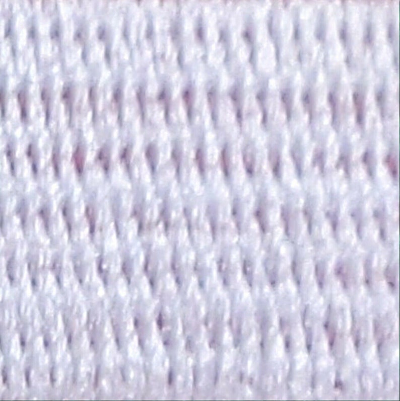 May include: White elastic band with a textured, woven pattern. The band is made of a soft, stretchy material.