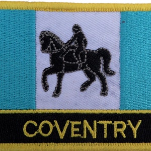May include: A yellow, black and turquoise embroidered patch featuring a black silhouette of a knight on horseback. The patch has the word "COVENTRY" in yellow lettering on a black background.