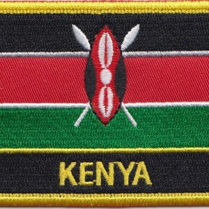 May include: Embroidered patch featuring the flag of Kenya. The flag is black, red, white, and green with a shield and spears in the center. The text "KENYA" is written below the flag.