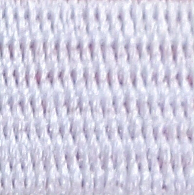 May include: White elastic band with a textured surface. The band is made of a soft, stretchy material.