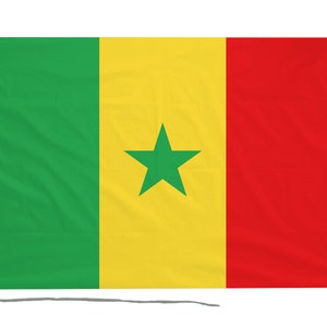 May include: The flag of Senegal, a rectangular design with three vertical stripes: green, yellow, and red. A green star is in the centre of the yellow stripe. The flag is attached to a white fabric strip and a wooden dowel.
