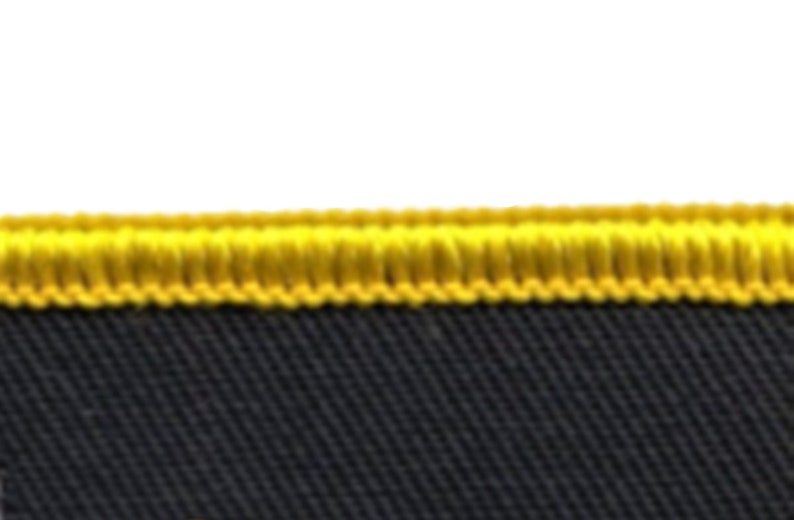 May include: Close-up of a black fabric with a yellow stitched border.