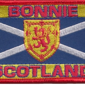 May include: An embroidered patch featuring the Scottish flag with the words "BONNIE SCOTLAND" and a yellow and red Scottish lion crest.