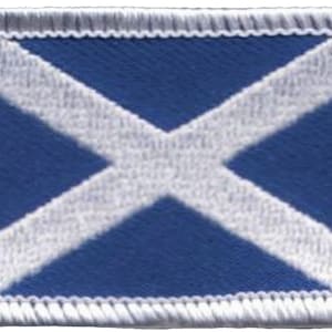 May include: A blue and white embroidered patch with a white cross on a blue background. The patch has a white stitched border.