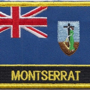 Könnte beinhalten: Ein gestickter Aufnäher mit der Flagge von Montserrat. Die Flagge ist blau mit einem Union Jack in der oberen linken Ecke und dem Wappen von Montserrat in der oberen rechten Ecke. Der Aufnäher hat einen schwarzen Hintergrund mit dem Wort "MONTSERRAT" in gelben Buchstaben.