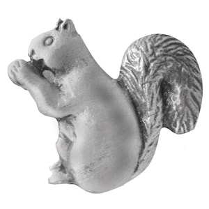 May include: A silver-colored squirrel figurine with a bushy tail, sitting on its haunches and holding a nut in its paws.