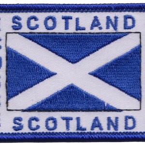 May include: White embroidered patch with a blue Scottish flag and the text "SCOTLAND" on the top and bottom.