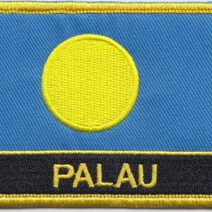 May include: A blue fabric patch with a yellow circle in the centre and the word "PALAU" in yellow letters on a black background.