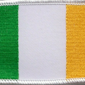 May include: A fabric patch with the colors of the Irish flag: green, white, and orange.