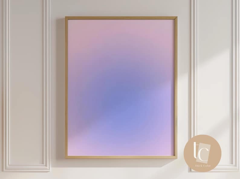 May include: A framed abstract art print with a gradient of pink, purple, and blue colors. The frame is gold and the print is in a modern style.