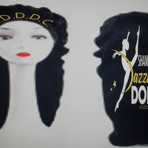 May include: Black satin sleep cap with gold embroidery. The embroidery on the front says "S.D.D.D.C." and the back says "Shanequa's Dazzling Dolls Dance Company".