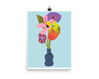May include: A blue vase with a geometric pattern holds a bouquet of colorful flowers. The flowers include pink, yellow, orange, purple, and green.