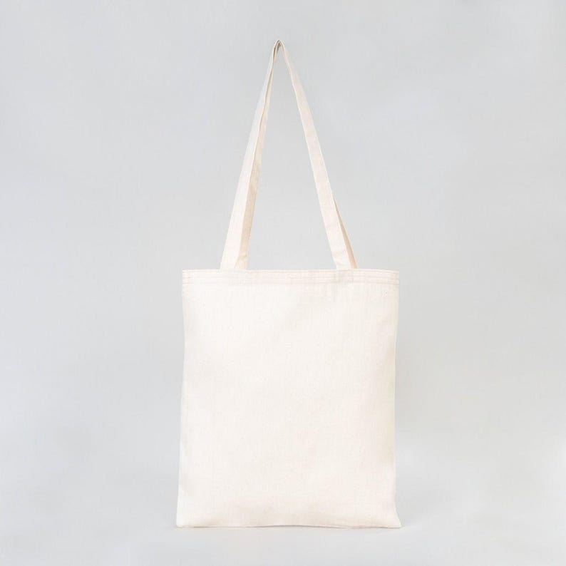 May include: A plain white canvas tote bag with two long handles.