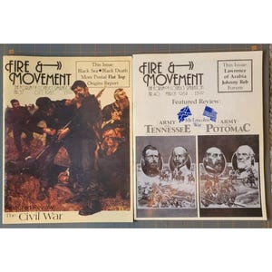 May include: Two vintage issues of "Fire & Movement" magazine. The first features a Civil War review and the second discusses Lawrence of Arabia. Both magazines have illustrations and text, with the publication title in a stylized font.