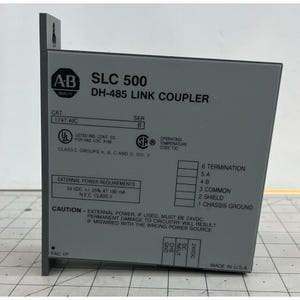 May include: A gray SLC 500 DH-485 Link Coupler with the AB Quality logo. The device has text including "External Power Requirements 24 VDC +/- 25% AT 190 mA" and "Made in U.S.A."