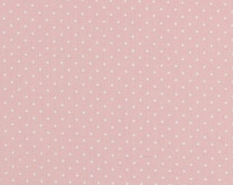 Puede incluir: Una tela rosa con un patrón de lunares blancos.