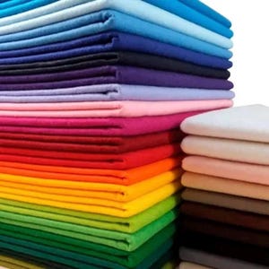 May include: A collection of felt fabric in a range of colours, from blues and purples to pinks, reds, and greens. The fabric is neatly stacked, displaying a vibrant array of hues. Suitable for various craft and creative projects.