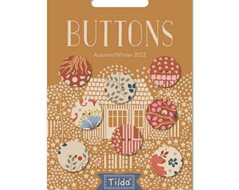 May include: A card with the word "BUTTONS" in large letters and the text "Autumn/Winter 2022" below. The card features a house with a garden and seven colourful fabric buttons with floral and geometric patterns.