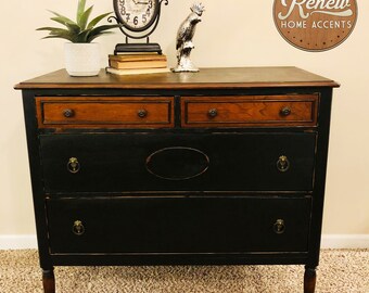 If your house is already full of antiques, why not find a dresser or chest of drawer from the same period. black dresser etsy