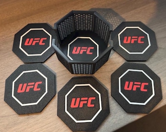 May include: A set of six black octagonal coasters with the UFC logo in red and white. The coasters are arranged around a matching black holder with a lattice design.