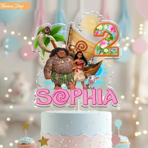 May include: A cake topper featuring characters from the animated film Moana, with the name "Sophia" in pink script. The number "2" is decorated with flowers. The cake is light blue and pink, with cupcakes and star decorations.