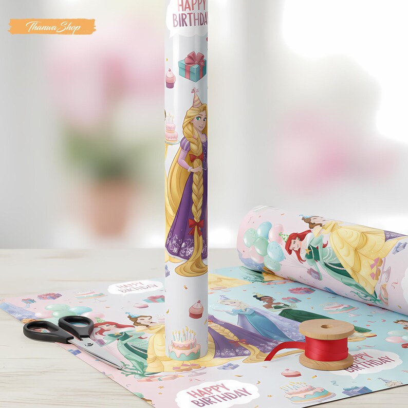 May include: A roll of white wrapping paper featuring a princess design with the text "HAPPY BIRTHDAY". The paper is decorated with images of cakes, gifts, and other princesses. A pair of scissors and a spool of red ribbon are also visible.