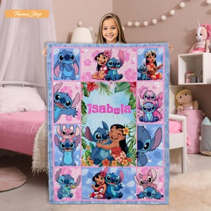 May include: A light blue and pink blanket featuring various images of the characters Stitch and Lilo from the Disney movie Lilo & Stitch. The blanket has a personalized name in the center and is surrounded by a blue border.