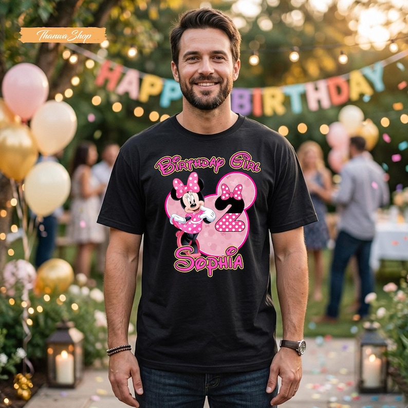 May include: A black short-sleeved t-shirt featuring a graphic of Minnie Mouse in a pink polka-dot dress next to a large pink number two. The text reads Birthday Girl and the name Sophia in a stylized pink font with a white outline.