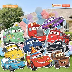 May include: A selection of colourful, cartoon car cutouts, including a green van, a red truck, and other vehicles. The cutouts are arranged on grass with balloons in the background, ideal for a party or event.
