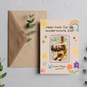 May include: A light brown card with a hand-drawn rainbow, sun, and flowers. A photo of a young girl is in the center of the card. The text "Vielen Dank f&uuml;r die wundersch&ouml;ne Zeit!" is at the top of the card. The text "Eure Maya" is at the bottom of the card.
