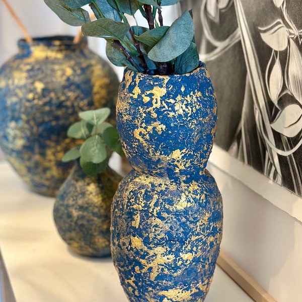 Tall vase in blue and gold papier-mâché.