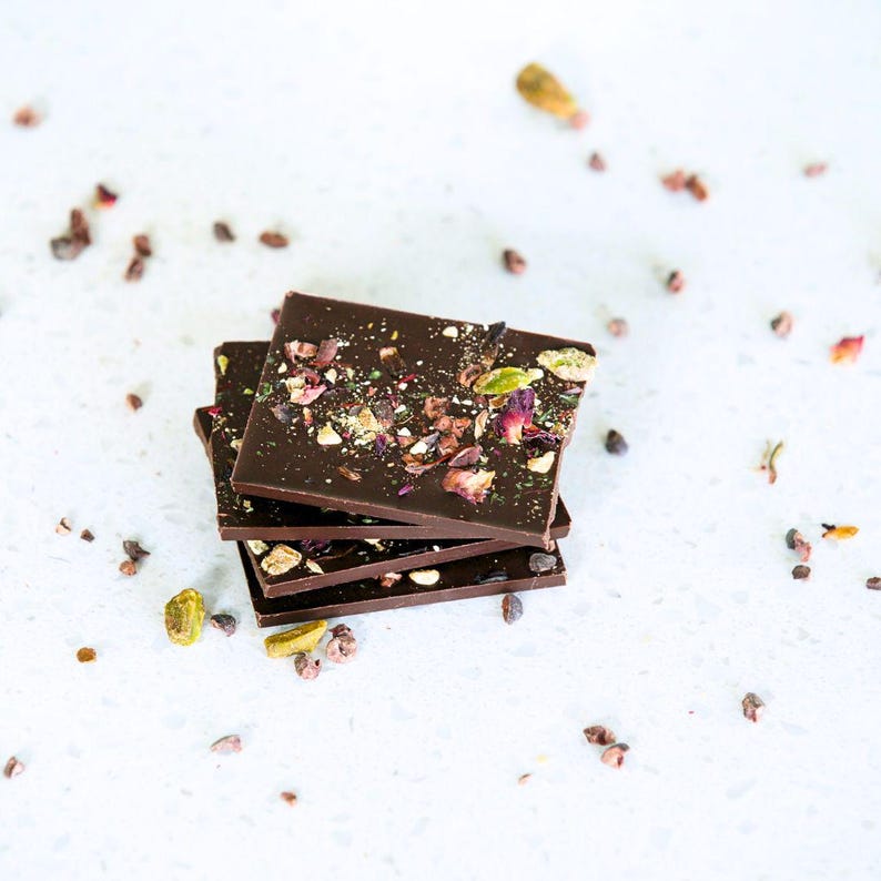 Dark chocolate bars with saffron, pistachios, rose petals, cacao nibs