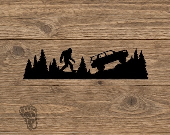 May include: A black metal wall art piece featuring a silhouette of Bigfoot walking through a forest of pine trees next to an off-road vehicle driving up a rocky incline. A small footprint icon is positioned in the lower left corner of the design.
