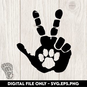 May include: Black graphic of a hand making a peace sign, with a paw print in the center. The words "DIGITAL FILE ONLY - SVG.EPS.PNG" are at the bottom. The background is a light wood grain.