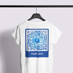 May include: White t-shirt with a blue square featuring a Facebook QR code and the text "YOUR TEXT" printed on the back.